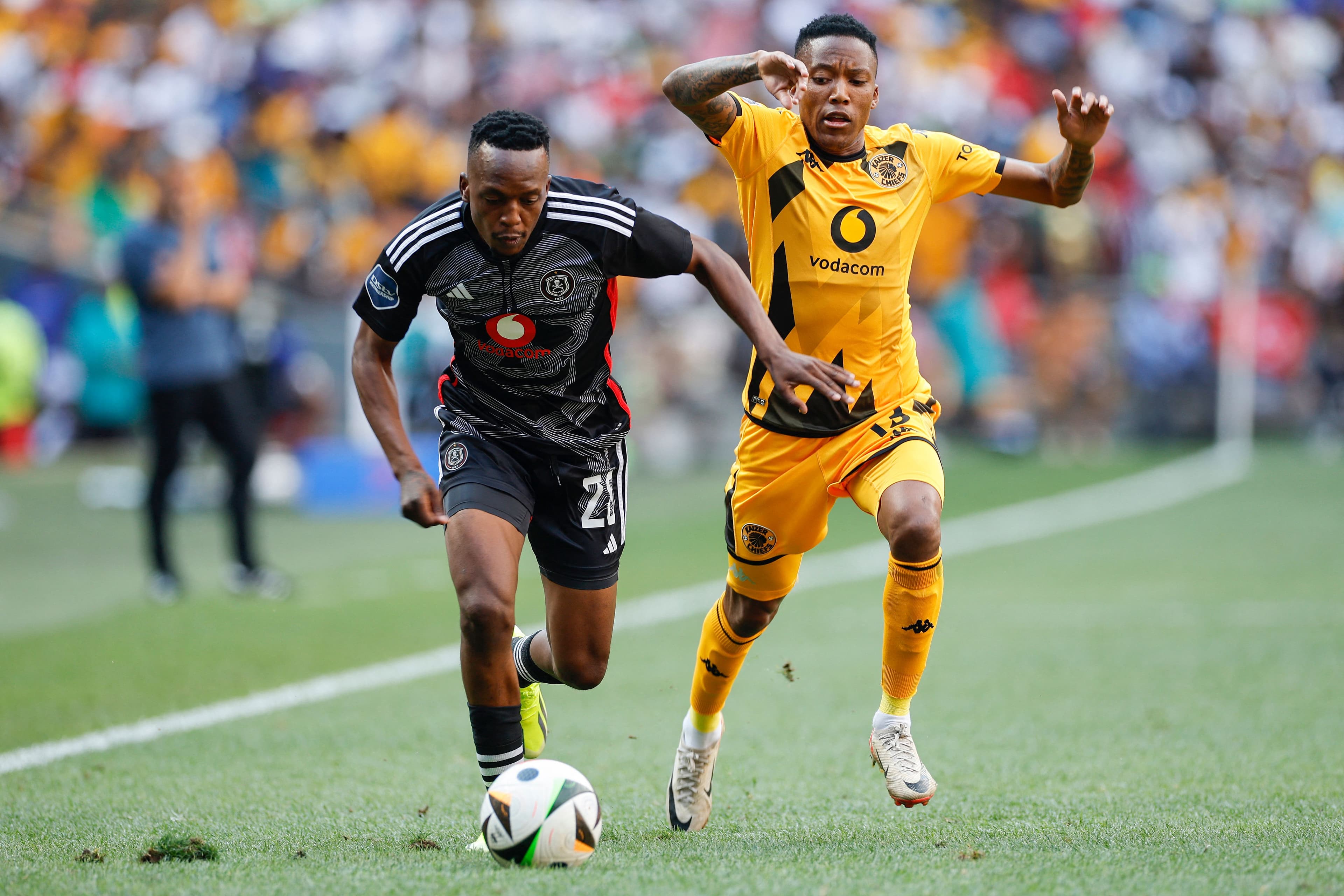 Patrick Maswanganyi vies for the ball with Pule Mmodi 