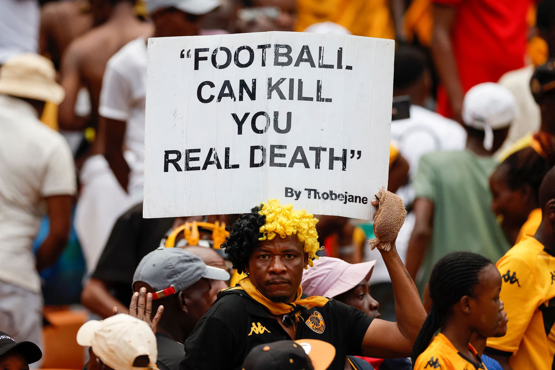 A Kaizer Chiefs fan holds a placard