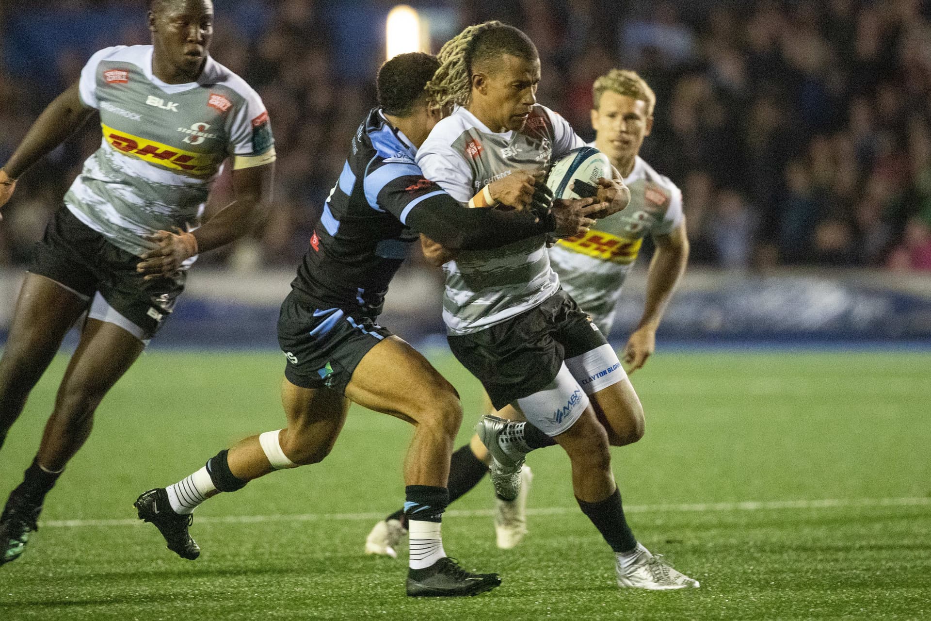 Clayton Blommetjies of Stormers gets tackled by Theo Cabango of Cardiff Rugby