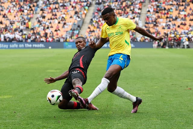 Pirates' South African defender #44 Mbekezeli Mbokazi (L) tackles Sundowns' South African midfielder #4 Teboho Mokoena