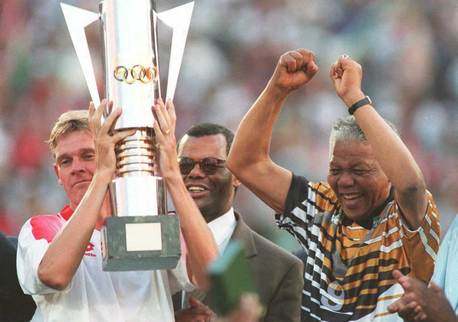 Nelson Mandela celebrates with the national football squad captain Neil Tovey