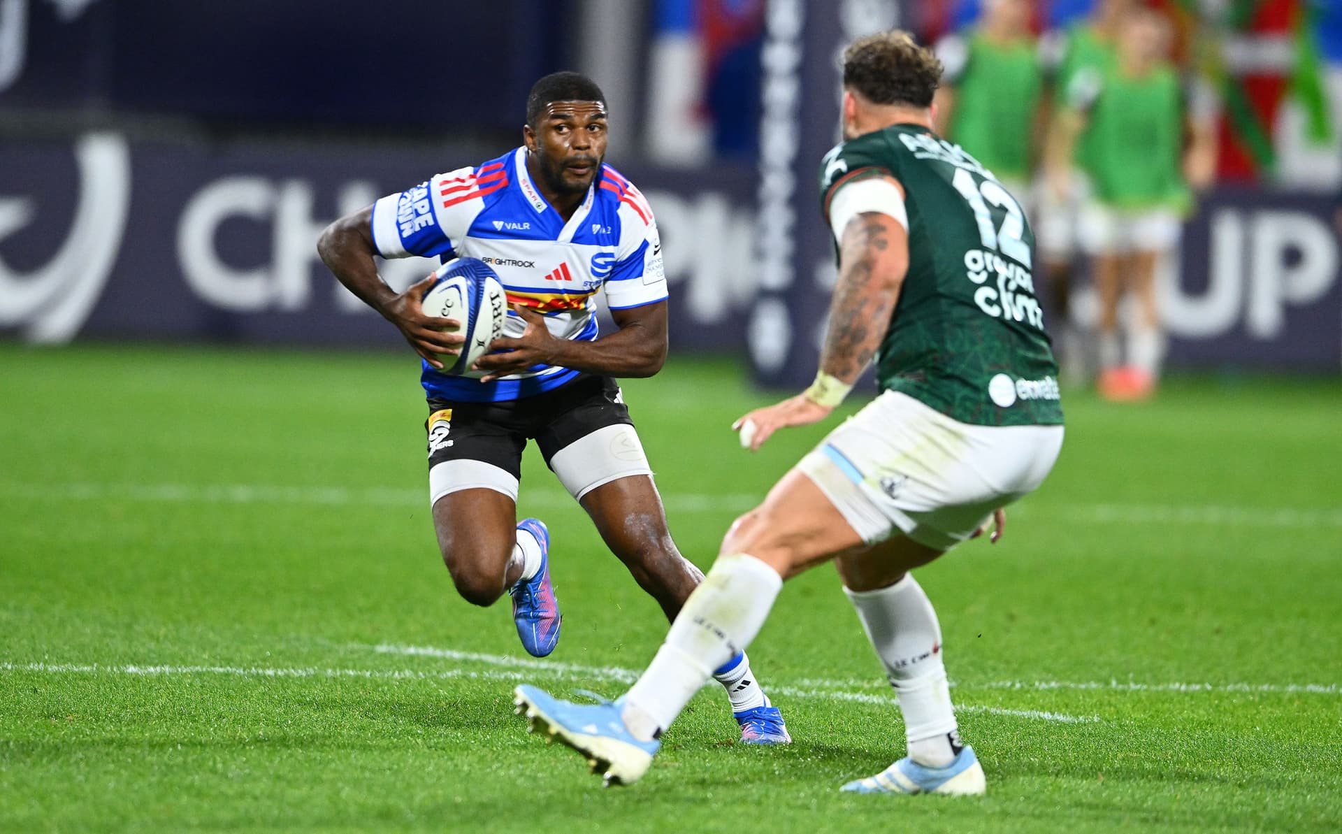 Stormers' South African winger Dylan Maart (L) runs with the ball during the European Rugby Champions Cup