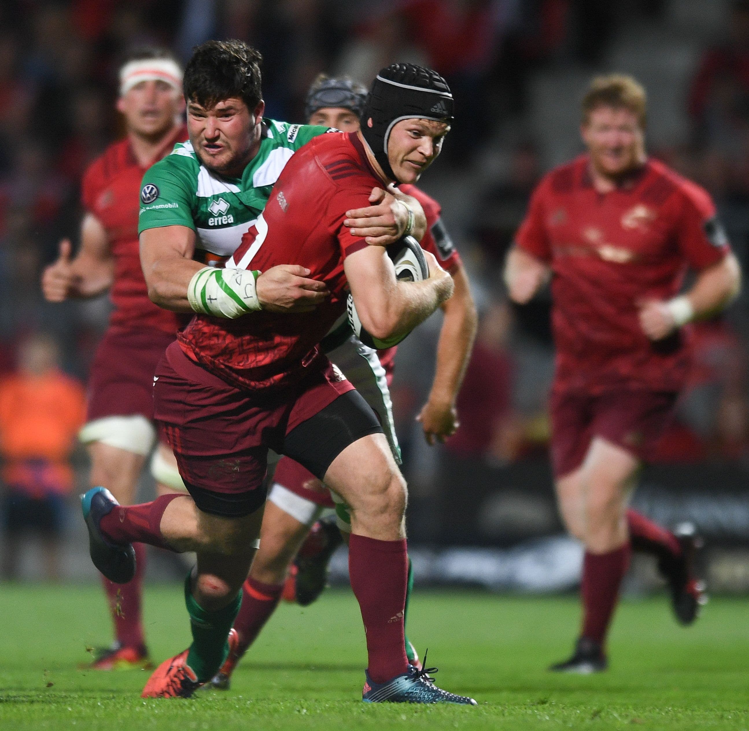 Tyler Bleyendaal of Munster is tackled by Sebastian Negri of Benetton